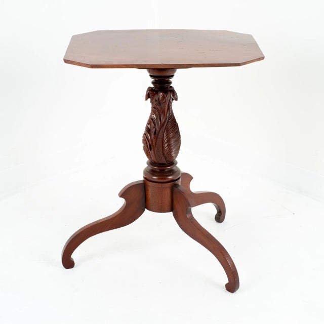 Rectangular single board tilt top tea table of dramatically figured mahogany with clipped corners. The top is supported by...