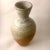 This vintage signed circa 1970 vase features a two-tone effect utilizing heavily textured raw terracotta at its base and a...