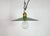 Vintage industrial enamel pendant lamp from the 1930s. It features a green enamel shade with white enamel interior and a...