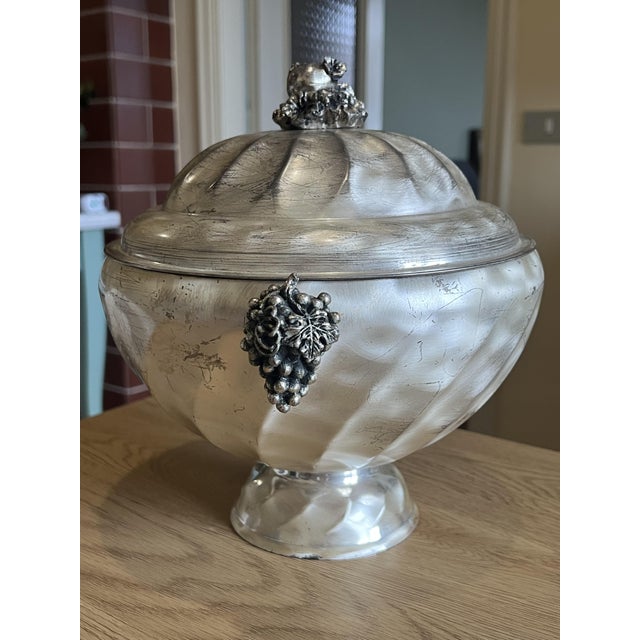 An artisanal lidded Italian Soup / Food tureen crafted in a silver-toned metal, distinguished by its softly fluted body...