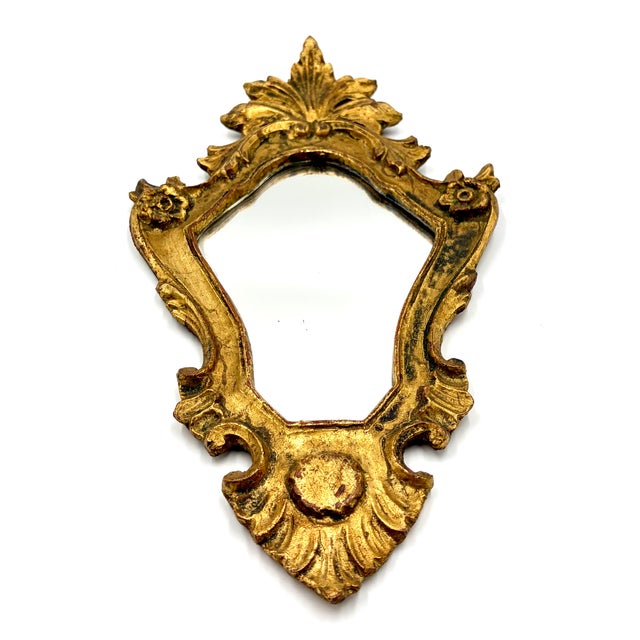 A beautiful Mid-Century petite Italian Florentine giltwood wall mirror. Marked "Made in Italy" on reverse. This gorgeous...