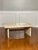 Solid marble and chrome coffee table in cream, 1990s. A striking table comprised of a marble top and base joined by a...