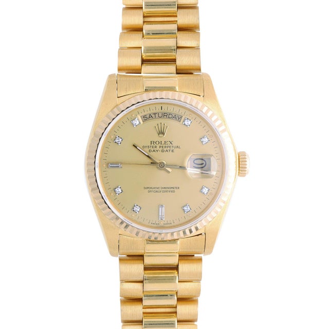 Rolex Oyster Perpetual Day-Date ref. 18038 in 18K yellow gold, circa 1978, featuring a champagne dial with diamond and...