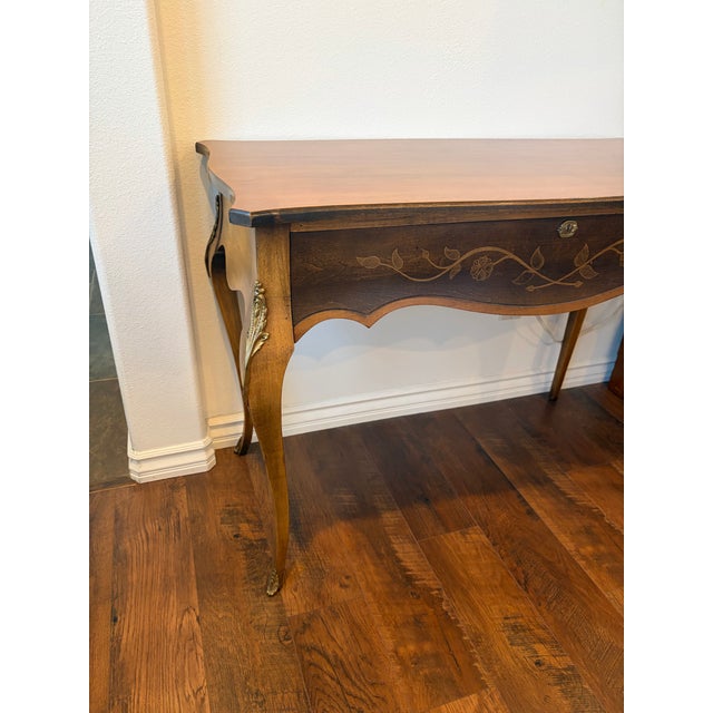 Exquisite Vintage French Provincial writing desk featuring floral marquetry inlay and brass mounts. I Style: French...