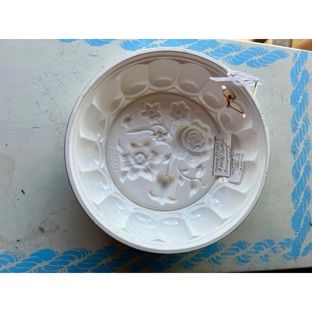 Round Ceramic Mold with Flowers . Made in Japan. Measuring 8.5"diameter and 2.5". This could be used to bake a cake in,...
