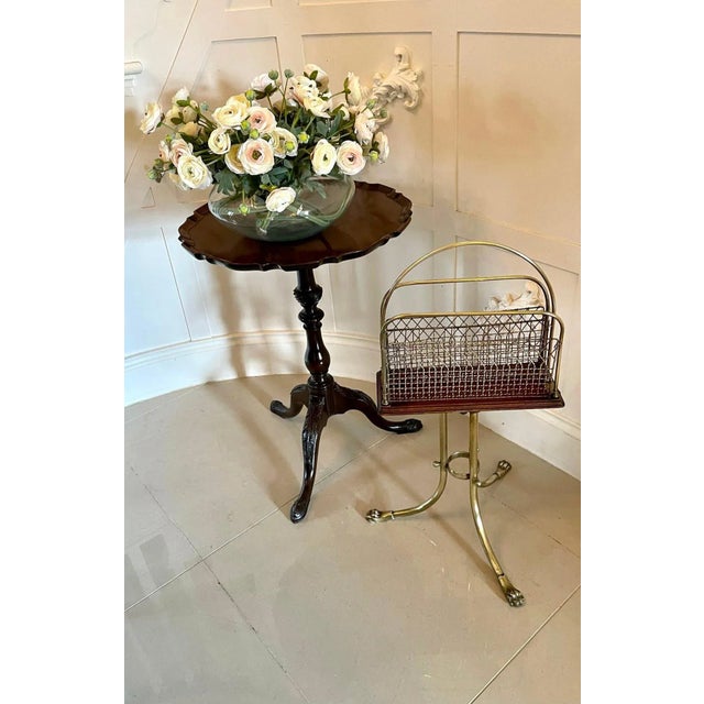 Quality antique victorian brass and mahogany revolving magazine stand having a shaped brass handle to the centre, two...