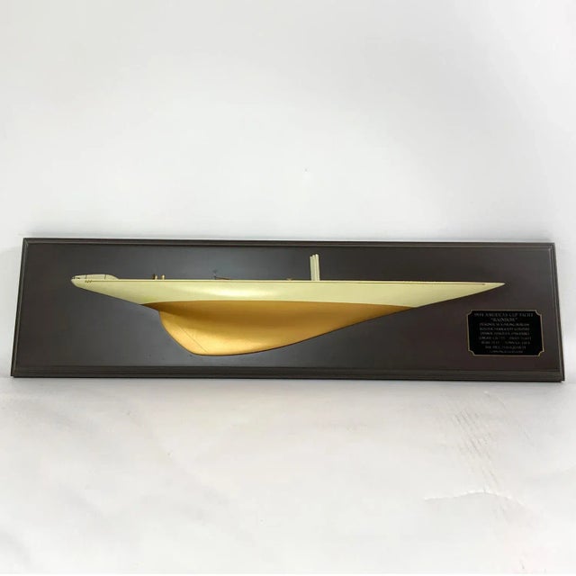 Fine carved wood half model of the 1934 Americas Cup Yacht Rainbow. Planked deck with brass fittings. Mahogany skylights...