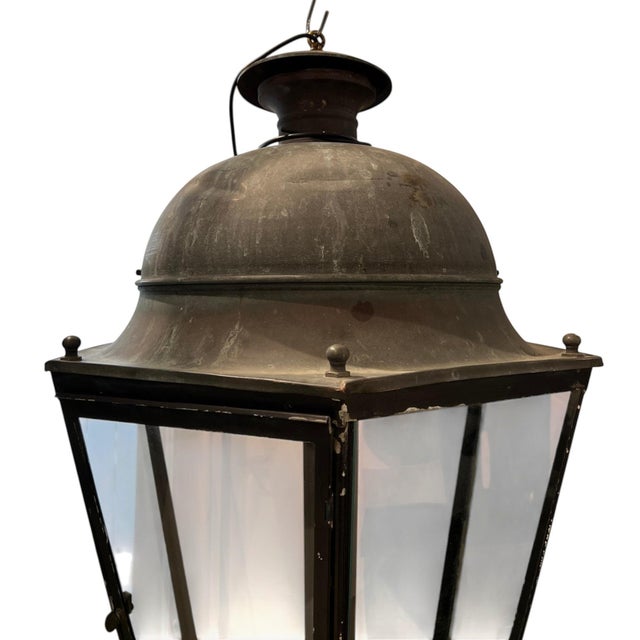 A striking 19th century French lantern crafted from iron and glass, featuring a generous scale and timeless architectural...