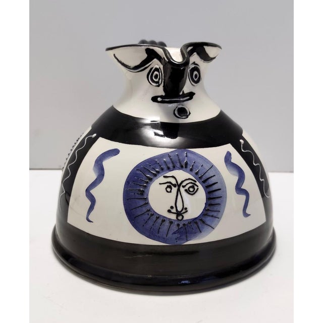 Made in France, 1960s - 1970s. It is made in white hand-painted ceramic with blue and black motifs, that recalls Pablo...