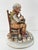 The Capodimonte sculpture signed by the artist Milio represents an elderly grandfather who is reading a fairy tale to his...