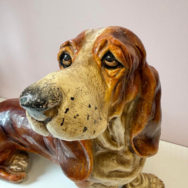 A fantastic vintage extra large basset hound sculpture composed of a molded resin-like material. Features stunning hand...