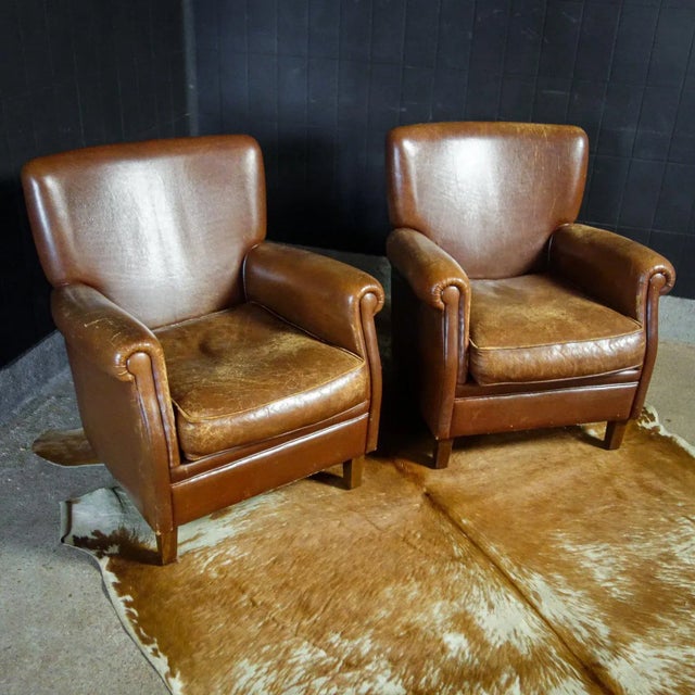 Deze vintage fauteuils zijn bestoft met bruin runderleer en vormen samen de ideale comfi-set voor in uw zithoek! Ook...