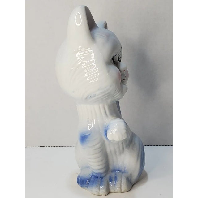 This is a fun and spunky little cat with a human-like face. It is predominately white with a traditional blue glaze and...