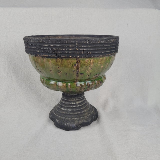 Artisan-crafted ceramic pedestal bowl features a striking combination of textures and glazes. The vessel showcases a...