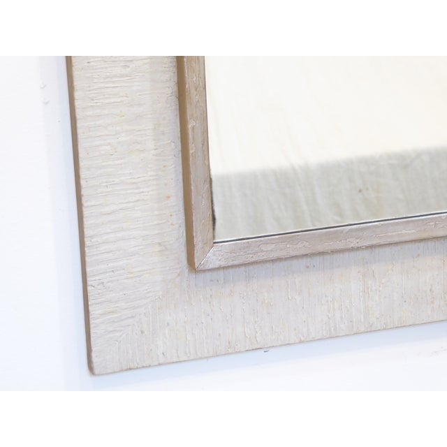 This modernist Heydenryk framed mirror has a textured white washed frame with a silvered trim. It is marked Heydenryk on...