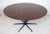 Mid-Century Modern round rosewood dining table with black metal star base. Table not marked.