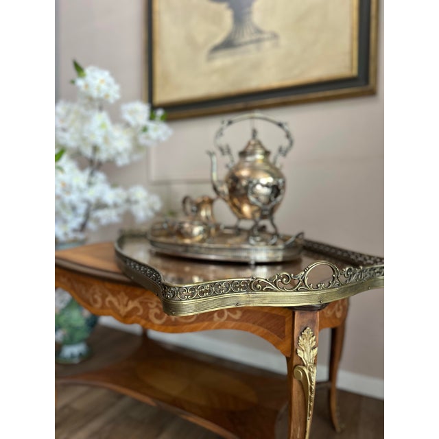Elegant inlaid serving table with a separate removable glass tray resting on top, finished with a pierced brass gallery....