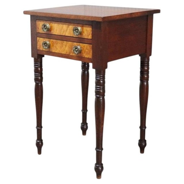 This antique Sheraton sewing stand, dating to approximately 1830, is crafted from rich mahogany and features striking...
