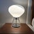 Modern mid century Kovacs mushroom table lamp. Shade is blown white and clear glass. Base is polished chrome. Switch sets...