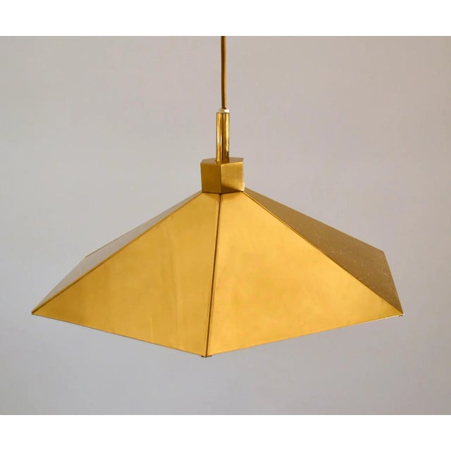 Angular brass pendant lamps pair in umbrella shape sheets of polished brass, 1970s Belgium. Inside they are enamelled to...