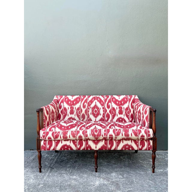 This striking vintage settee beautifully marries traditional Georgian elegance with the vibrant energy of global textiles....