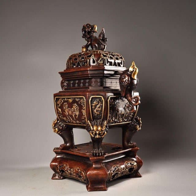 This impressive incense burner is crafted from bronze with a rich, dark reddish-brown patina and accented with bright...