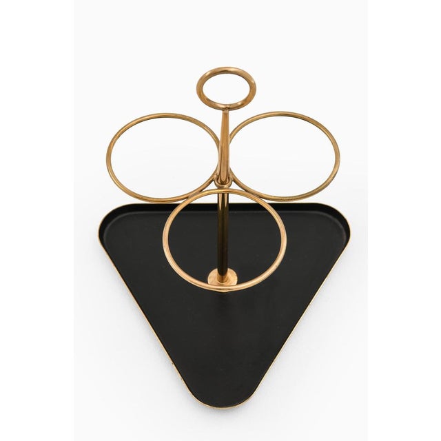 The bottle stand designed by gunnar ander and produced by ystad metall in sweden during the 1950s is a clear...