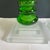 A pair of vintage 1960’s Danish candle sticks. The large candle sticks are in a green glass with opaque square bases. The...