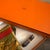 This authentic Hermès silk carré features the iconic "Masques et Casques" design by artist Julia Abadie, a masterpiece...