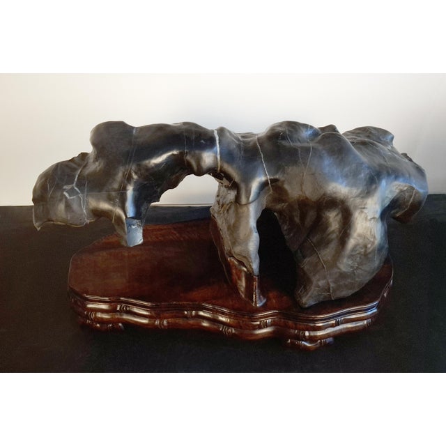 Large Chinese crouching beast gongshi, a large, heavy, horizontal, viewing stone, in blacks, greys, oranges and umbers,...