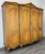 This impressive Vintage French Louis style wardrobe features an elegant four-door design with richly carved detailing, a...