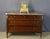Three-drawer commode with a marble top. This Louis XVI commode from the late 18th century is adorned with brass moldings...