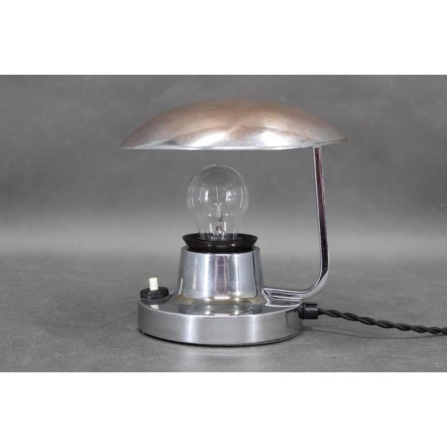 Original bauhaus adjustable table lamp designed and produced by napako in czechoslovakia in the 1940s. The lamp features a...