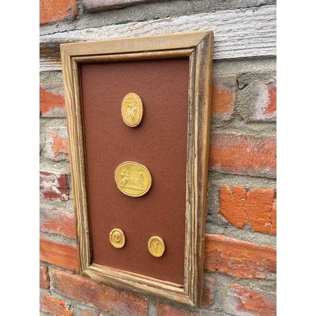 Immerse yourself in the enduring allure of classical antiquity with this truly unique collection of framed intaglios....