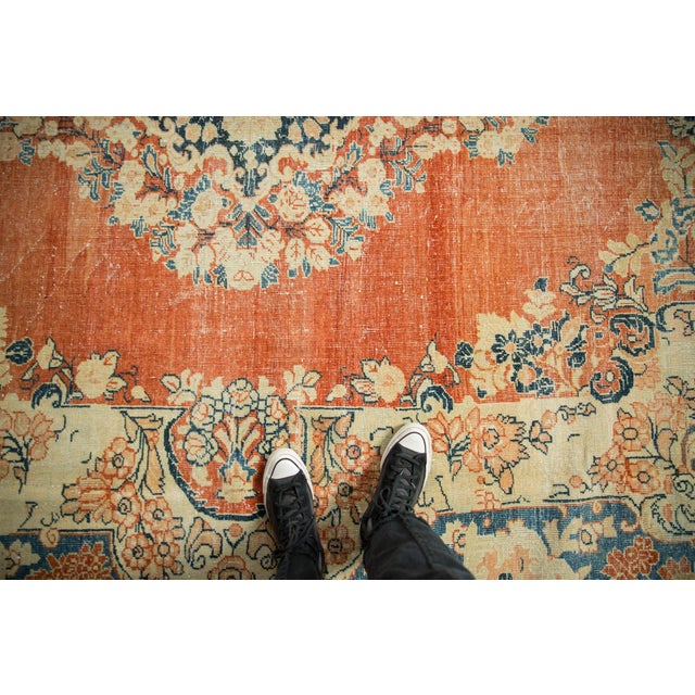 :: Shield-like center medallion with floral bouquets enveloping the perimeter atop an open abrashed ground with field...