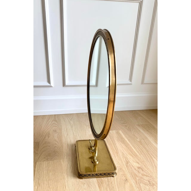 A striking vintage brass tabletop mirror from Italy with an intricate pierced star-pattern border and beautifully sculpted...