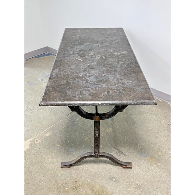 A late 19th century French cast iron bistro table with marble top from the L. Buchon Foundry in St. Etienne, France. It...