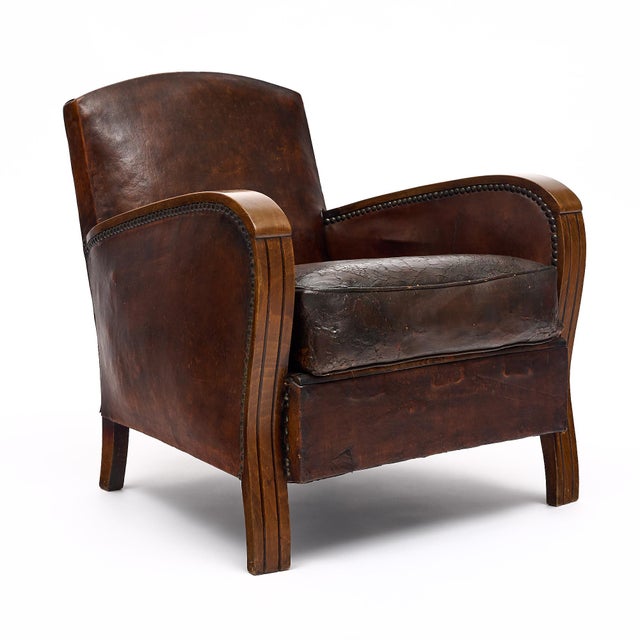 Club chair from Art Deco period France. This chair has the original leather with some wear consistent with age and use....