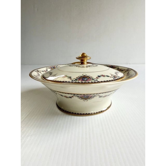 Fine porcelain covered dish with beautiful gold and floral details.