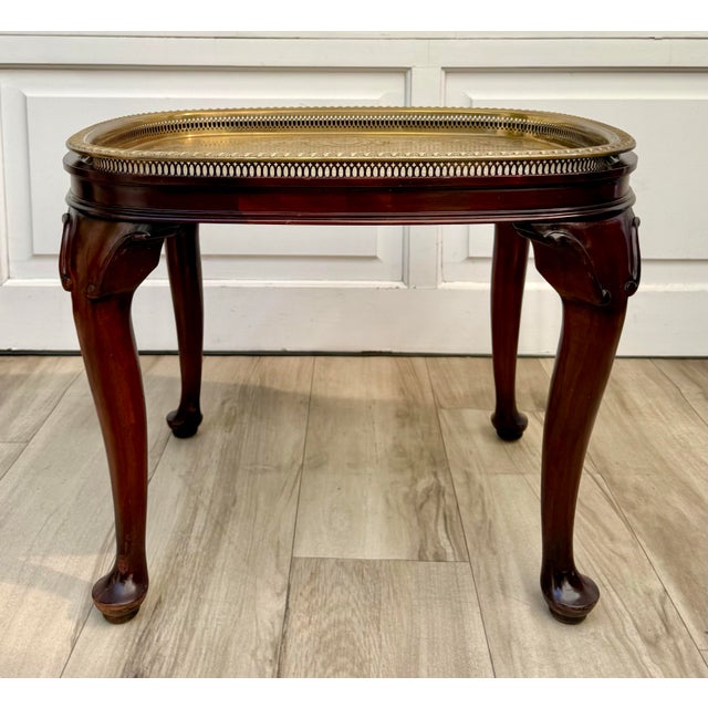Here is a mid-20th century Queen Anne style side table featuring a beautifully detailed removable brass tray over a rich...