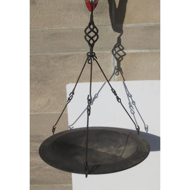 Vintage 90s' wrought Iron hanging tray. Heavy built with spirling details and interlocking hooks to hang with ease, it...