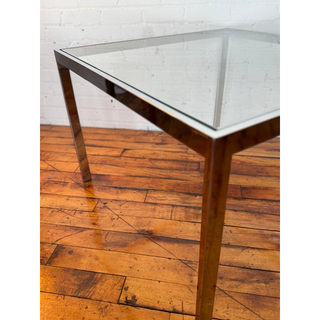 Up for offer is a 1970s glass and chrome side table in the style of Milo Baughman. This piece is in very good condition...