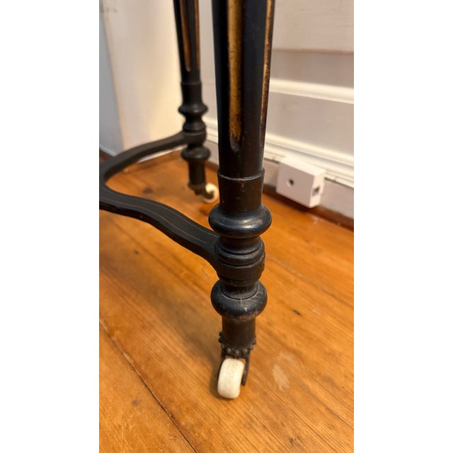 Antique Aesthetic Movement round side table: burl veneer top inside a wide ebonized band with gilt edge, fluted tapering...