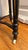 Antique Aesthetic Movement round side table: burl veneer top inside a wide ebonized band with gilt edge, fluted tapering...