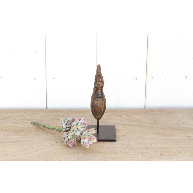 A beautiful small wood artifact from Southeast Asia originally used as a hand grinder. This antique decorative tool from...