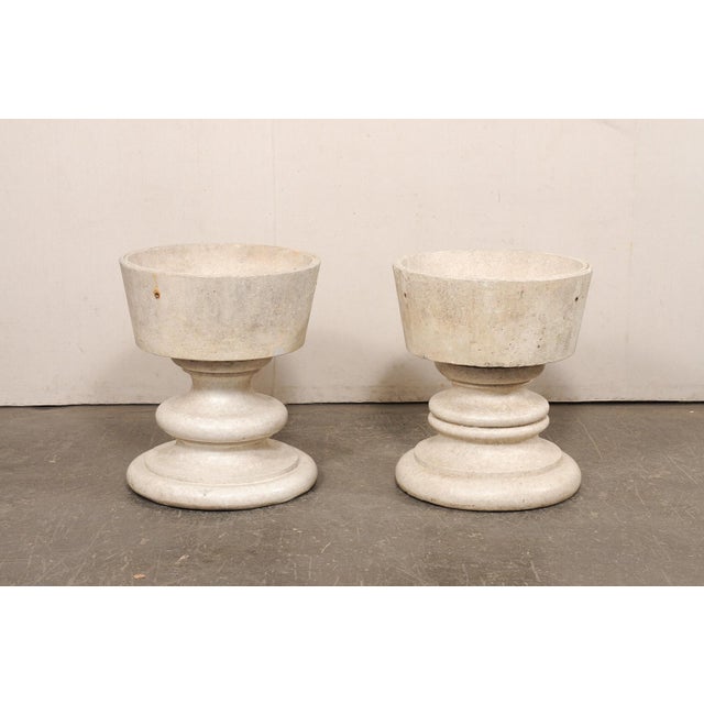 A fabulous pair of large-sized pedestal planters. This pair of vintage American planters have cast-stone, cleanly-...