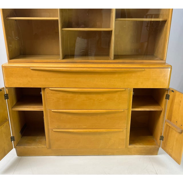 Mid-Century Modern two-piece china cabinet and hutch by Heywood-Wakefield, manufactured on January 14, 1952. Crafted from...