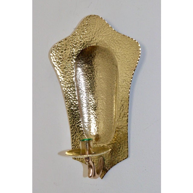 Source and Made in Sweden Elegant Pair of Swedish wall sconces crafted from hammered repoussé brass. these pieces blends...