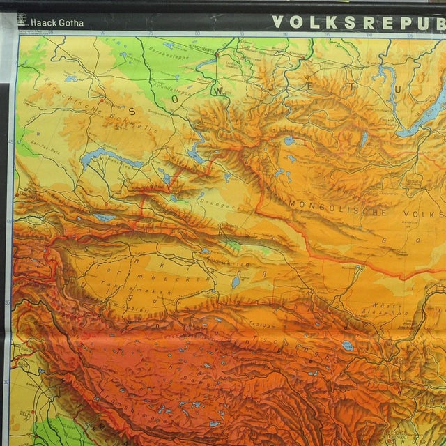 A vintage wall chart illustrating a map of people's republic of china. Used as teaching material in German schools....