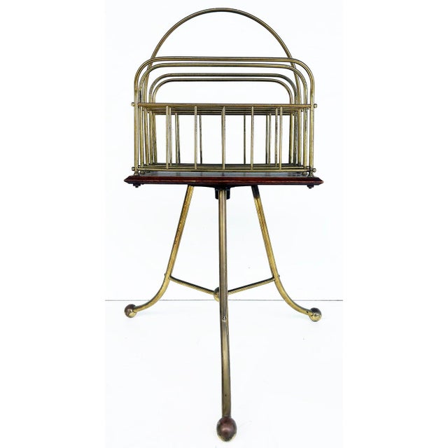Jans of London Antique Revolving Magazine Stand in Brass and Mahogany Offered for sale is an English Jans of London...